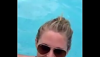 Outdoor oral pleasure captured on mobile device in a public pool setting