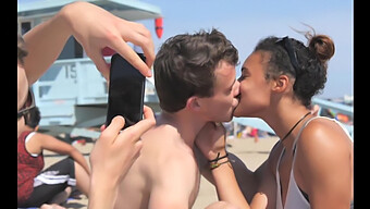 Black And White Teens Engage In Passionate Kisses On The Beach